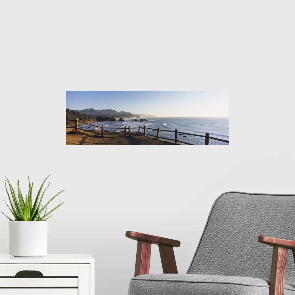 A modern room featuring Giant panoramic photograph featuring a railing overlooking Cannon Beach in Oregon (OR) on a sunny...