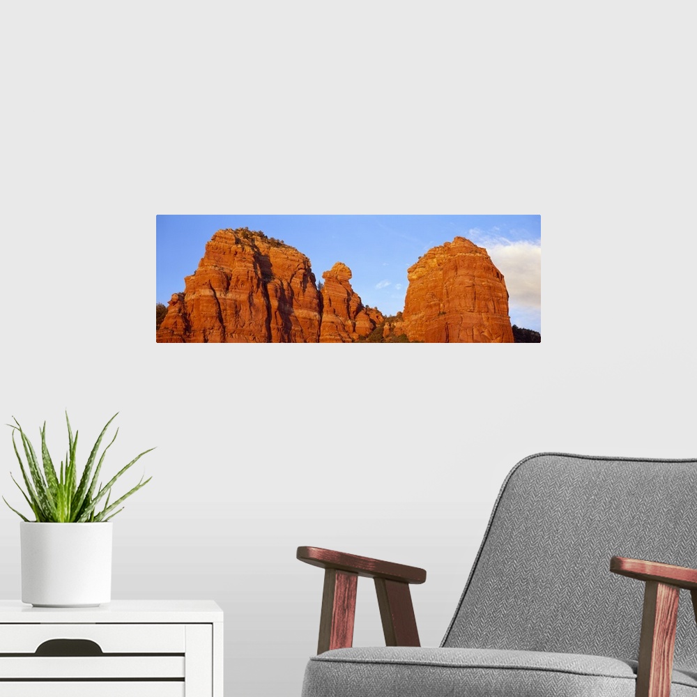 A modern room featuring Panoramic photograph of giant rock formations beneath an almost clear blue sky, in Sedona, Arizona.
