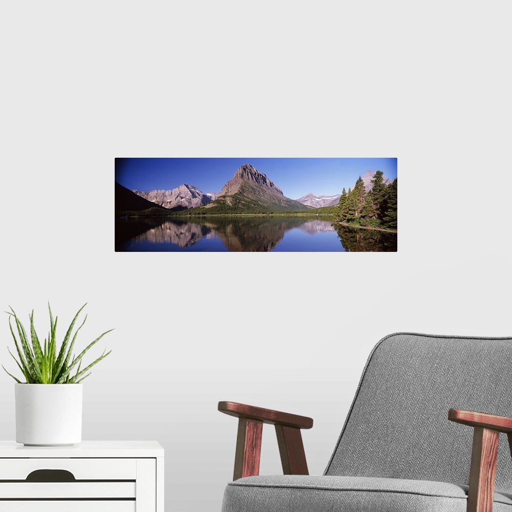 A modern room featuring Reflection of mountains in a lake, Swiftcurrent Lake, Many Glacier, US Glacier National Park, Mon...