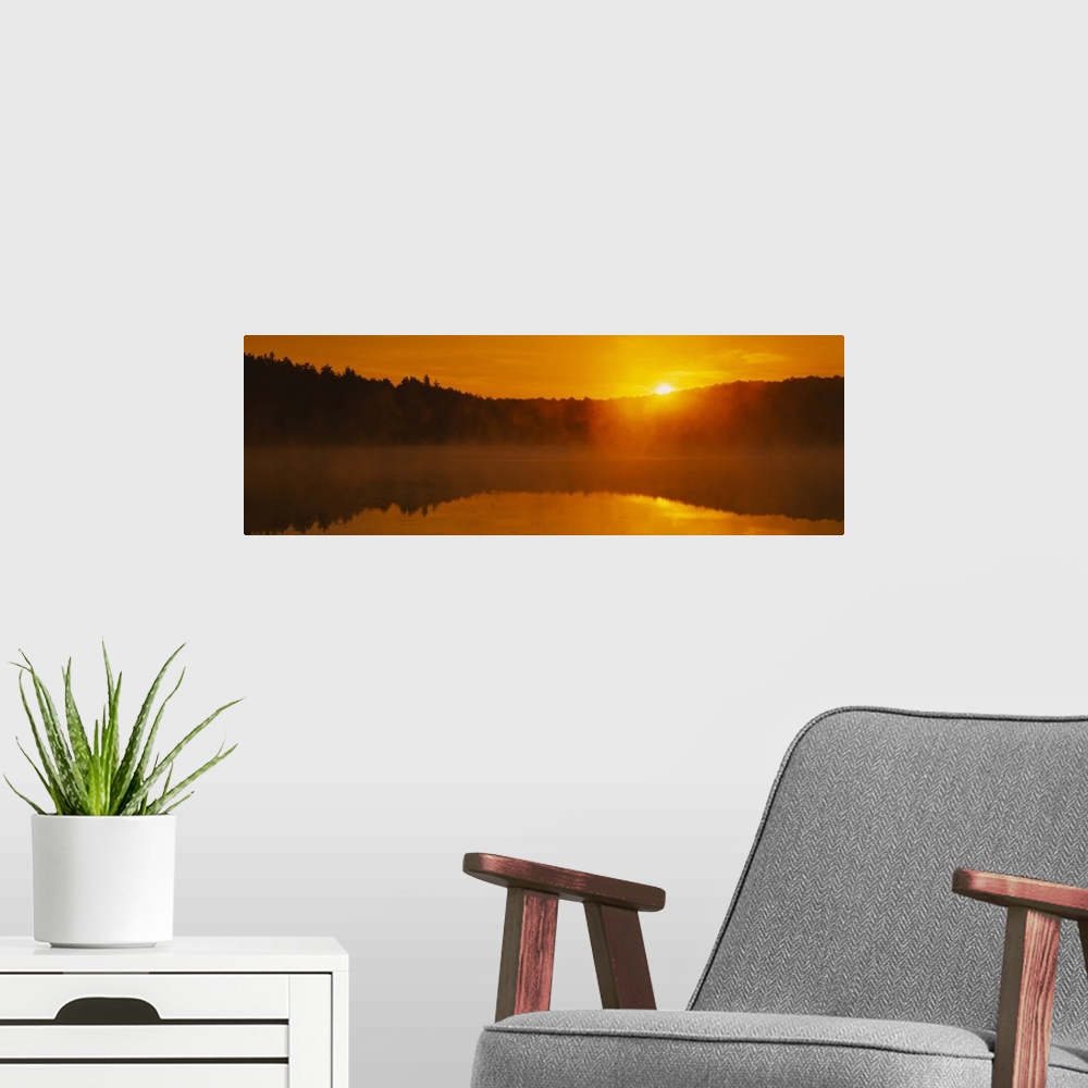 A modern room featuring Reflection of sun in the pond at sunrise, Vermont
