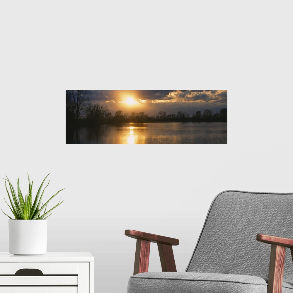 A modern room featuring Sunset reflecting over a lake in West Memphis, Arkansas.