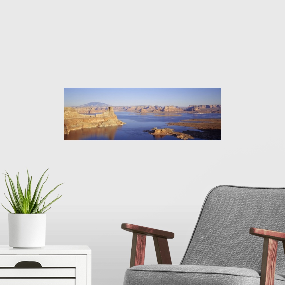 A modern room featuring Panoramic photograph of huge rocks and canyons in river under a clear sky.