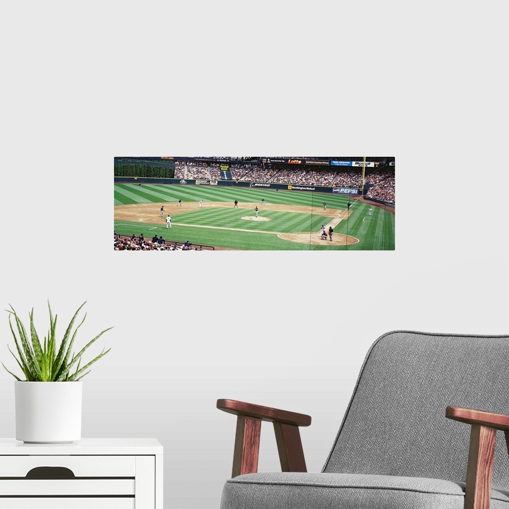 A modern room featuring Panoramic photograph is taken inside the Seattle Mariners baseball stadium as they play a game an...