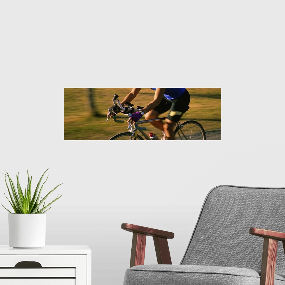 A modern room featuring Side profile of a woman cycling