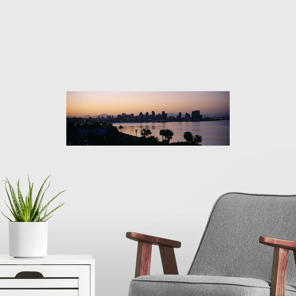 A modern room featuring Panoramic photograph taken from an aerial view overlooking the distant skyline of a busy city sit...