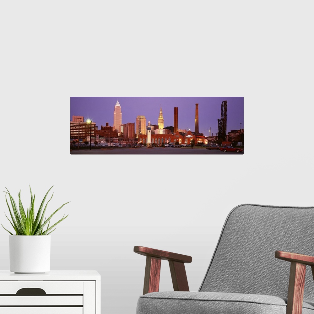 A modern room featuring Panoramic photograph of skyscrapers in Cleveland, Ohio, lit up at night.