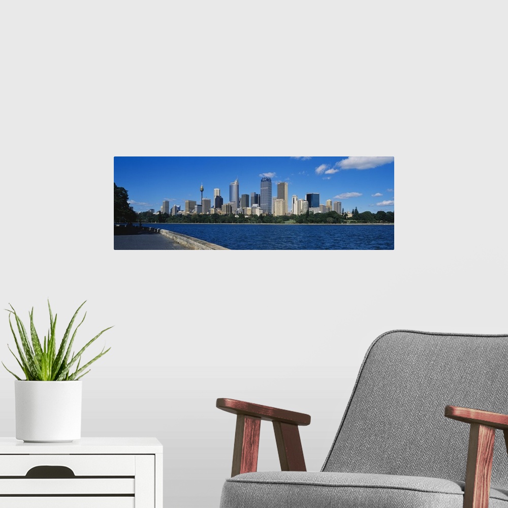 A modern room featuring Skyscrapers along a waterfront, Sydney, Australia