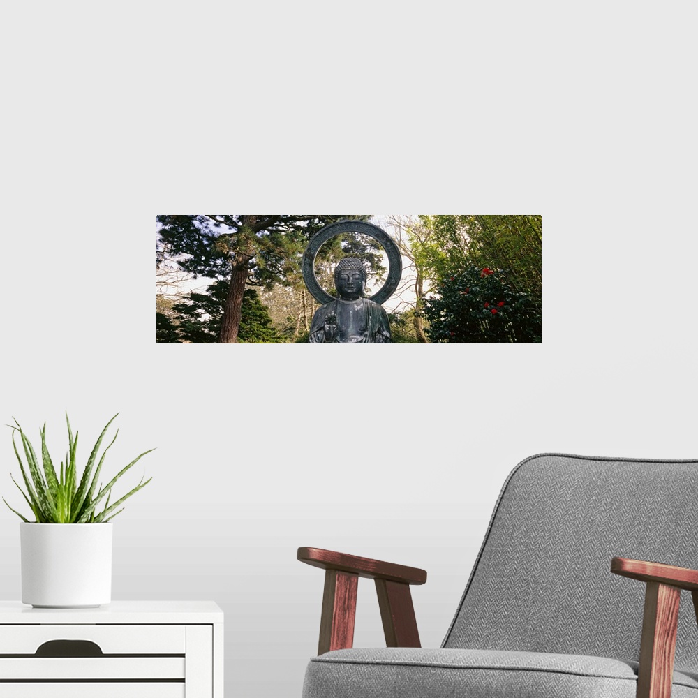 A modern room featuring This Buddha statue is pictured as a panorama with trees scattered about in the background.