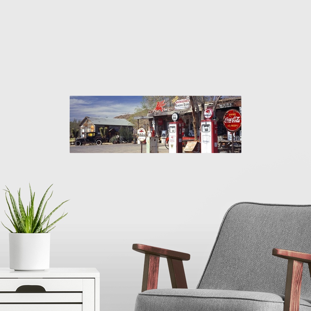A modern room featuring Long panoramic photo on canvas of a vintage Route 66 gas station with an old car outside.