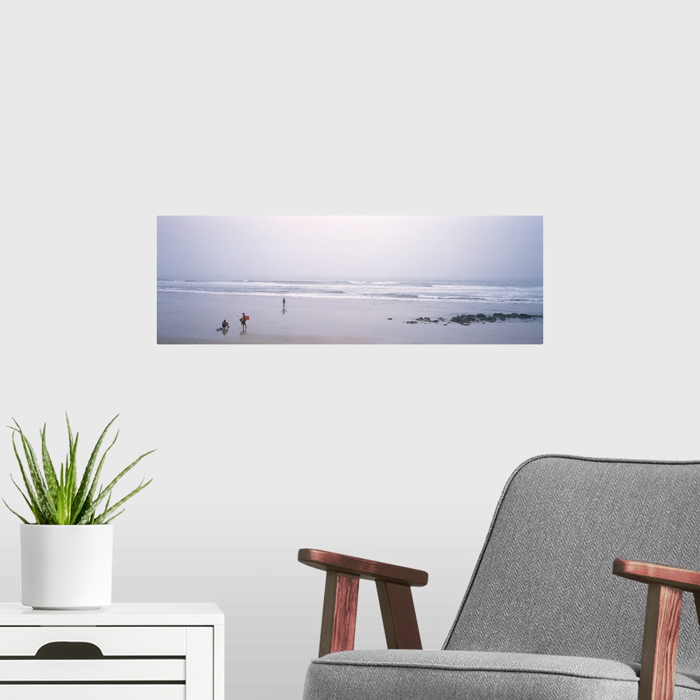 A modern room featuring Surfers carrying surfboards on the beach, San Mateo County, California,