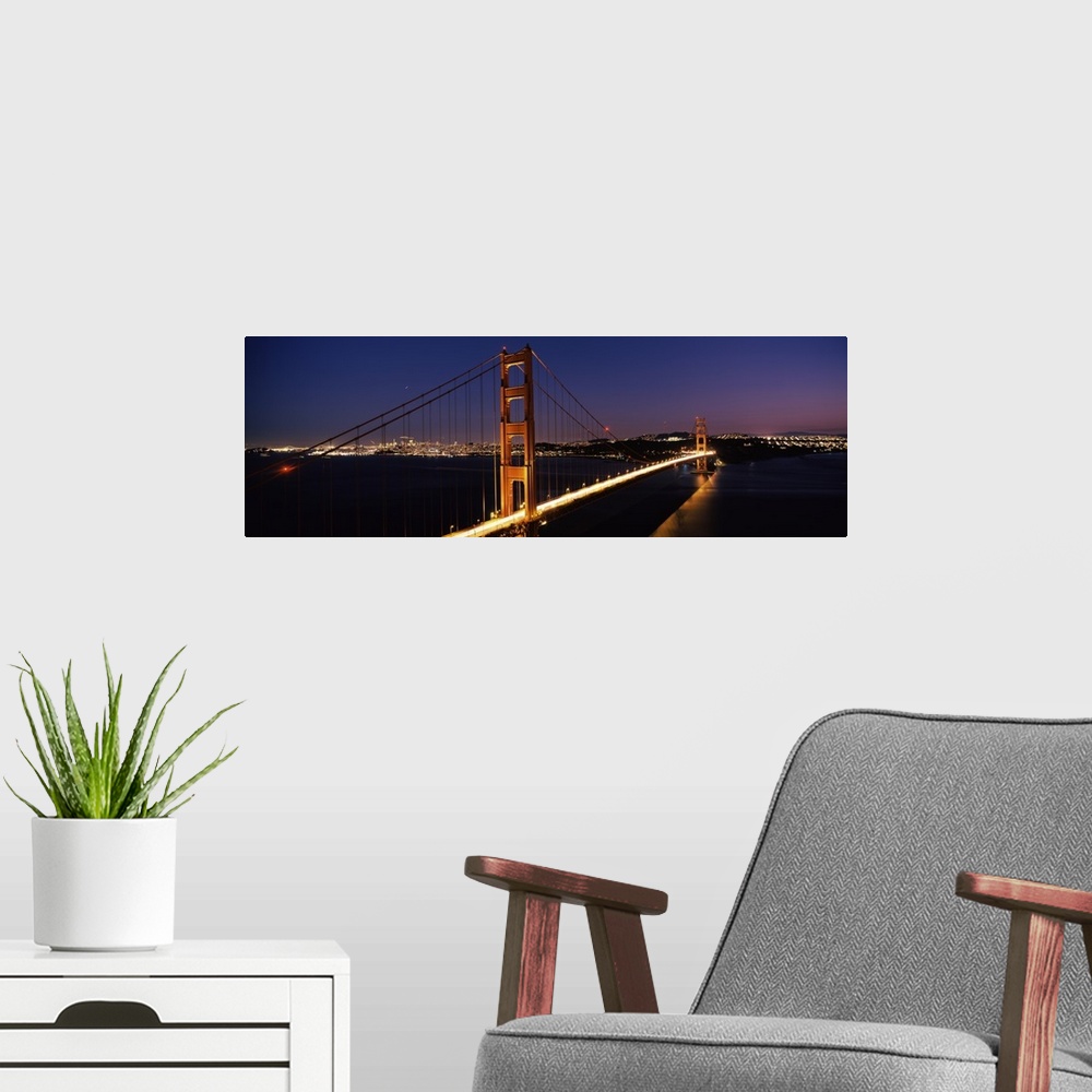 A modern room featuring Panoramic photograph of overpass at night with the city skyline in the distance.  The overpass is...
