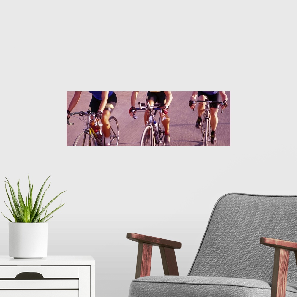 A modern room featuring Three women cycling