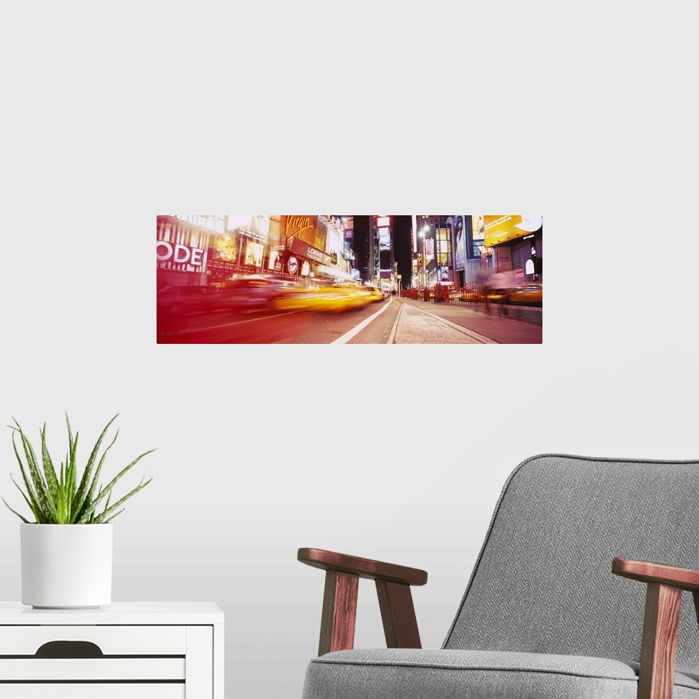 A modern room featuring Big, horizontal photograph of blurred traffic driving down the road leading through Times Square,...