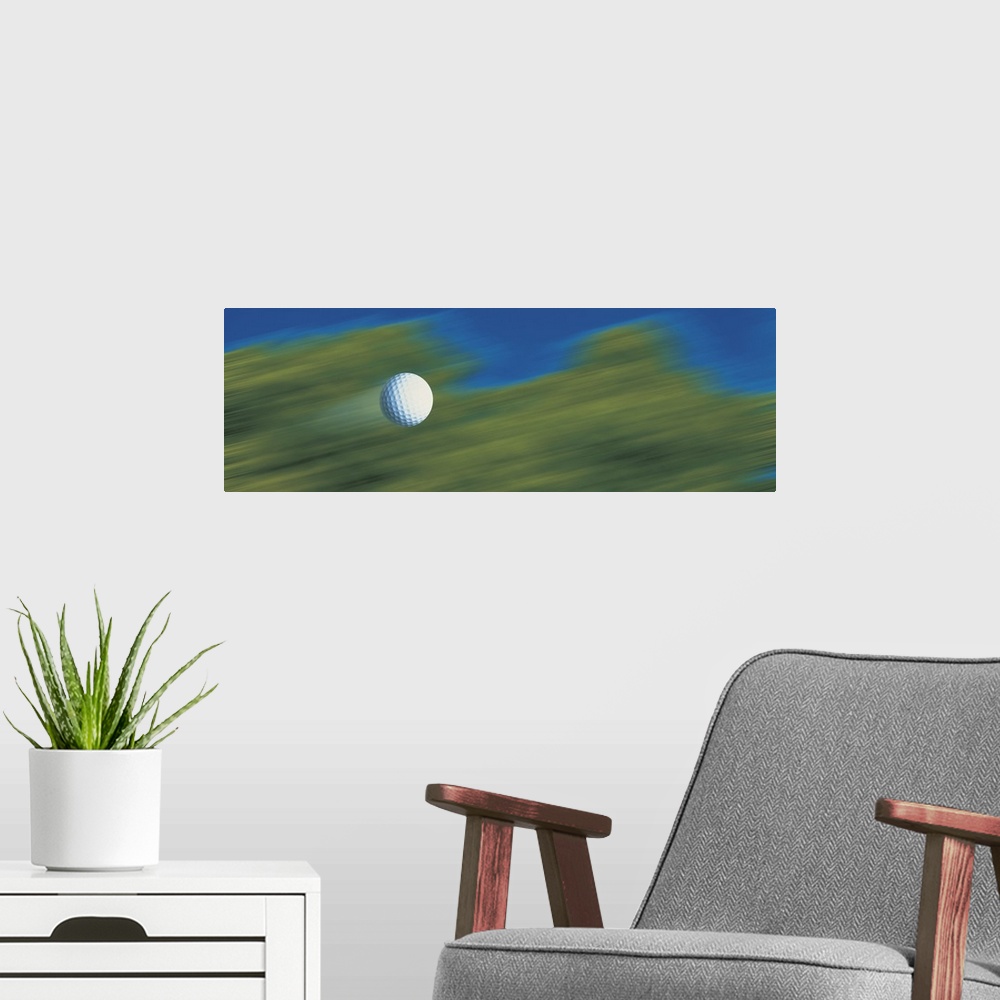A modern room featuring This decorative accent for the home or office of a golf enthusiast shows a golf ball speeding thr...