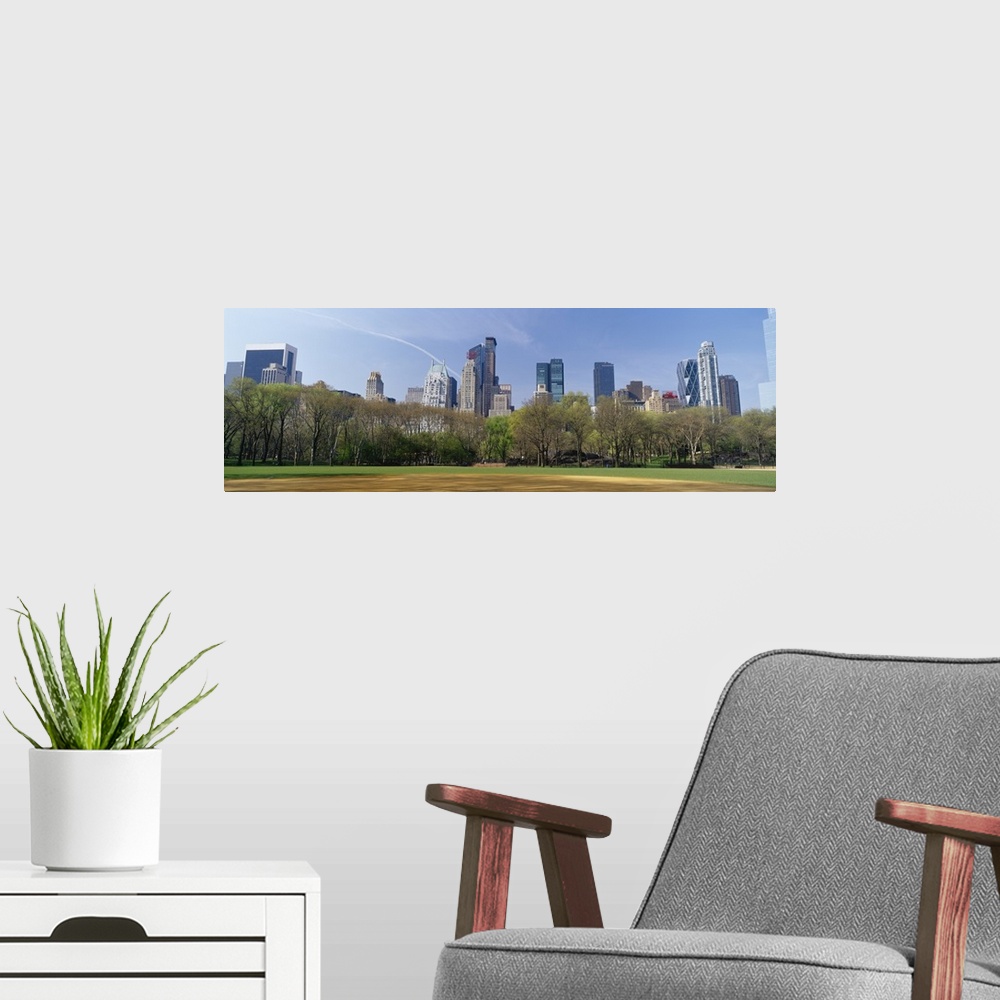 A modern room featuring Trees in a park with buildings in the background, Central Park South, Central Park, Manhattan, Ne...