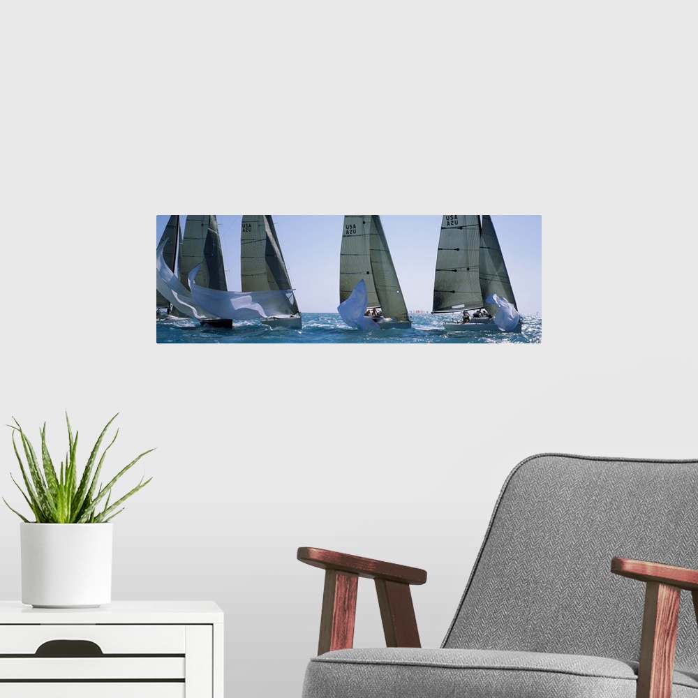 A modern room featuring Giant, wide angle photograph of five yachts racing on a sunny day, in the waters of Key West, Flo...
