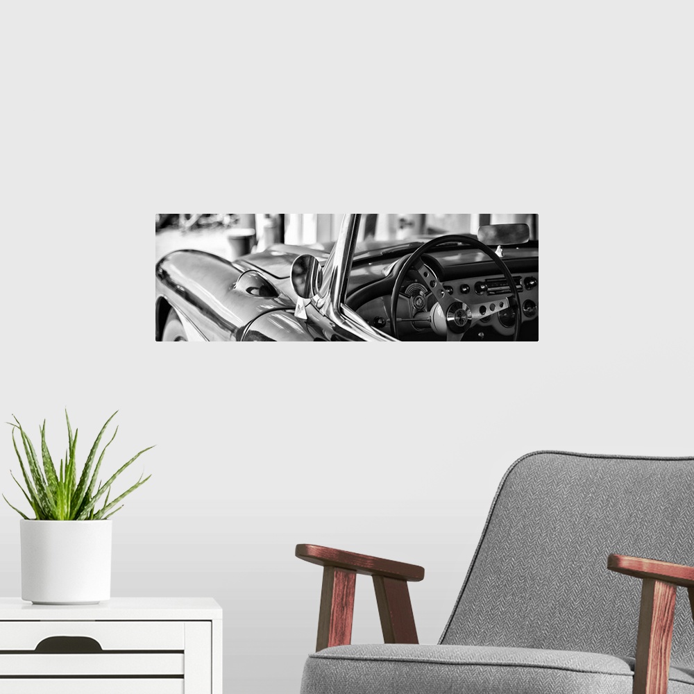 A modern room featuring Black and white photograph of a classic Chevy convertible on the beach.