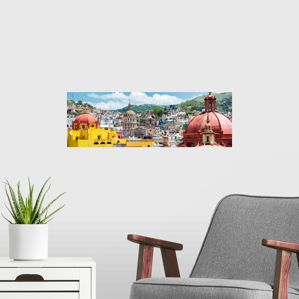 A modern room featuring Panoramic photograph of a cityscape in Guanajuato, Mexico, with colorful buildings and church dom...