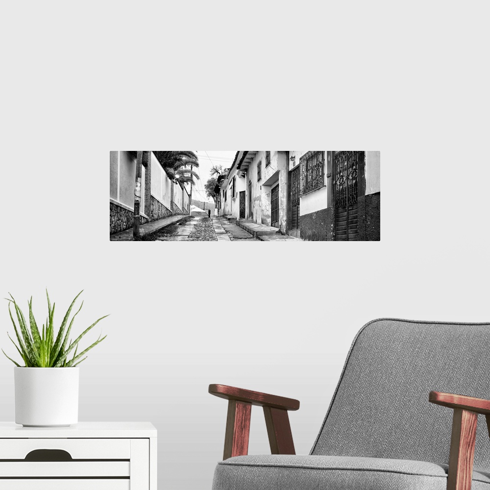A modern room featuring Black and white panoramic photograph of a streetscape at San Cristobal de Las Casas in Chiapas, M...