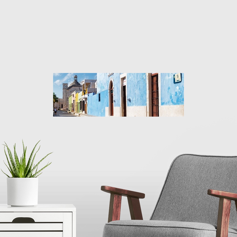 A modern room featuring Panoramic photograph of a street scene in Campeche, Mexico, with a bright blue building. From the...