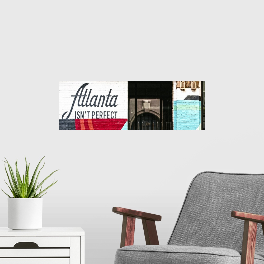 A modern room featuring Atlanta Isn't Perfect, geometric mural featuring a quote by Ryan Gravel, on the side of Switchyar...
