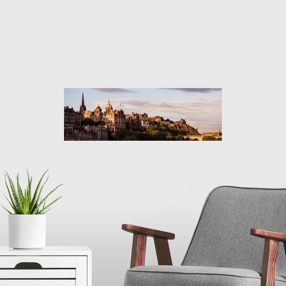 A modern room featuring Panoramic photograph of part of the city of Edinburgh with the castle in the background, at golde...