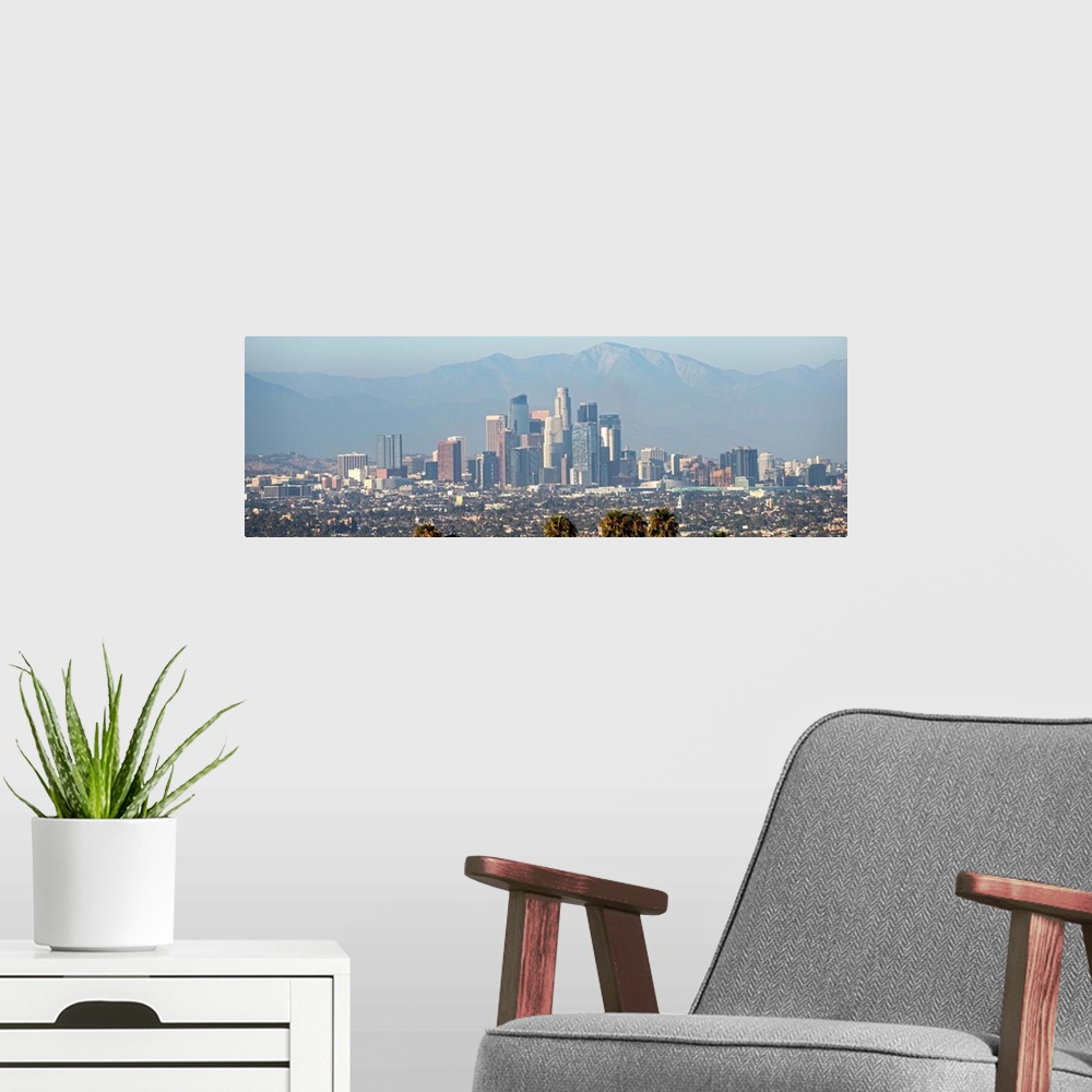 A modern room featuring Panoramic photograph of the Los Angeles, California skyline with mountains in the background and ...