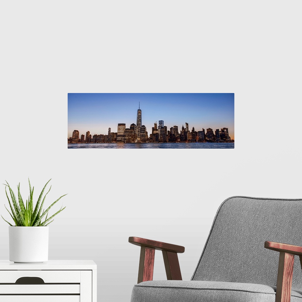 A modern room featuring Panoramic view of the New York City skyline over Manhattan in the morning.