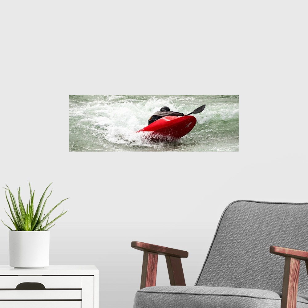 A modern room featuring A person paddling in a kayak in whitewater rapids.