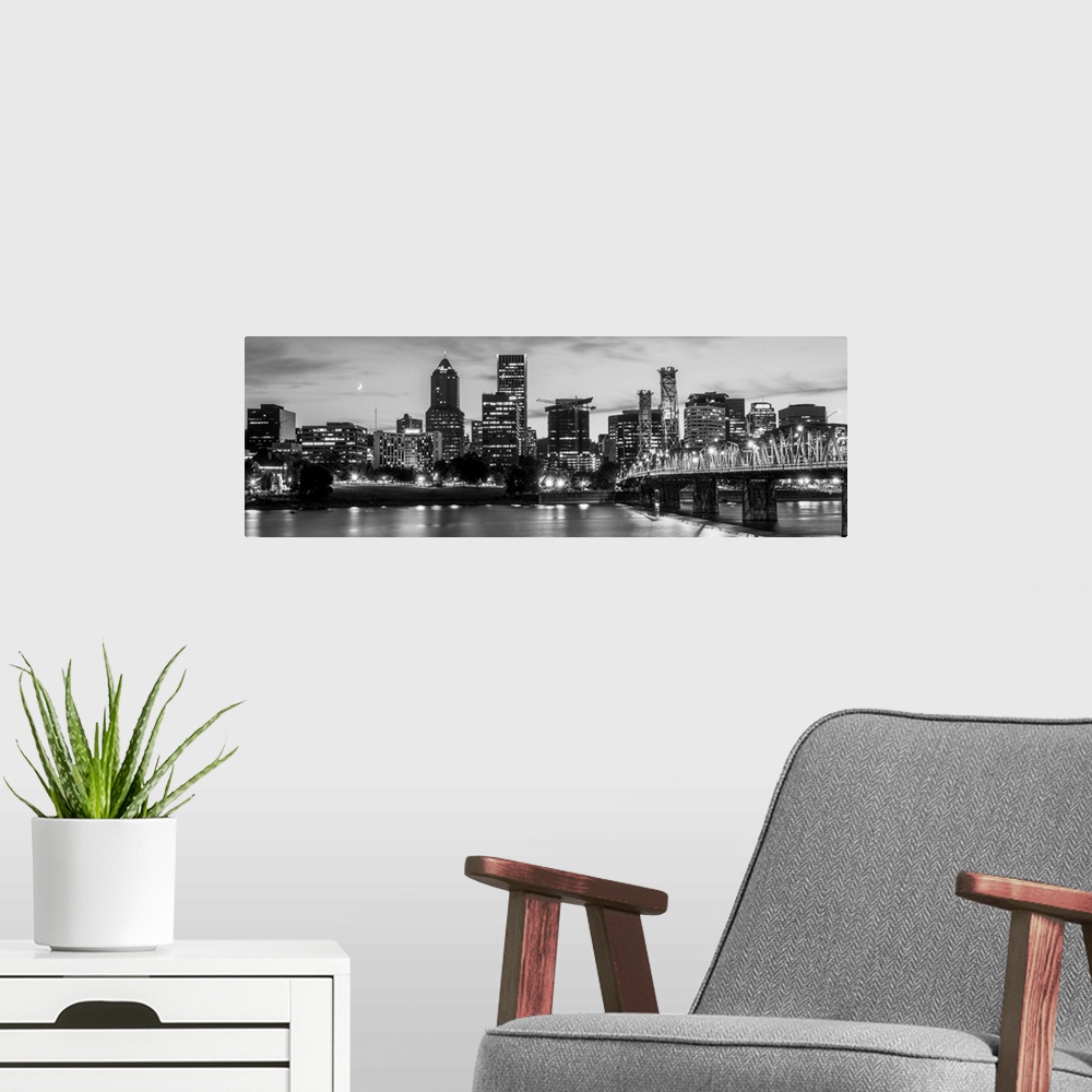 A modern room featuring Panoramic photograph of the Portland, Oregon skyline lit up with lights at the beginning of sunse...