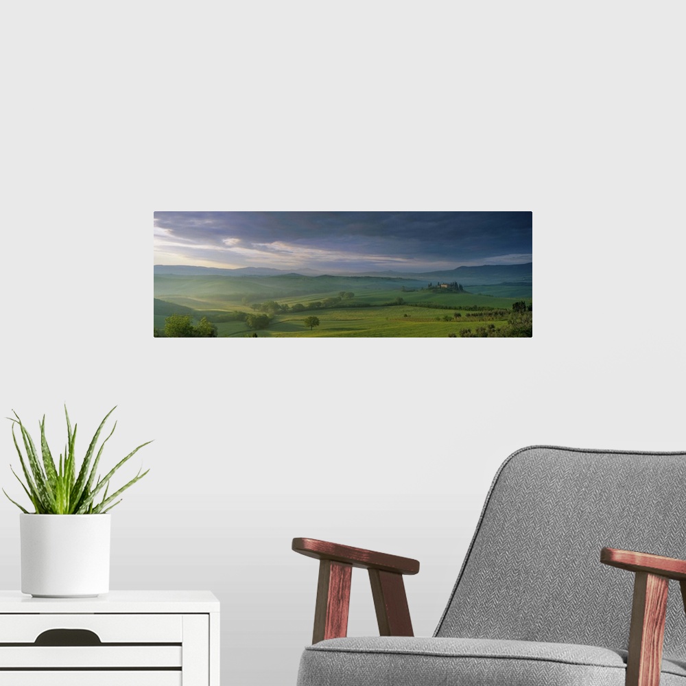 A modern room featuring Panoramic view of Belvedere and the Val d'Orcia at dawn, in spring, Tuscany, Italy