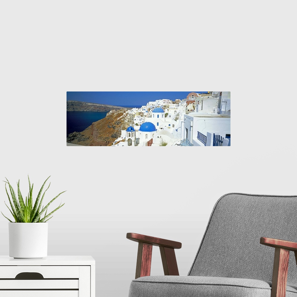 A modern room featuring View of Oia with blue domed churches, Santorini, Greek Islands, Greece