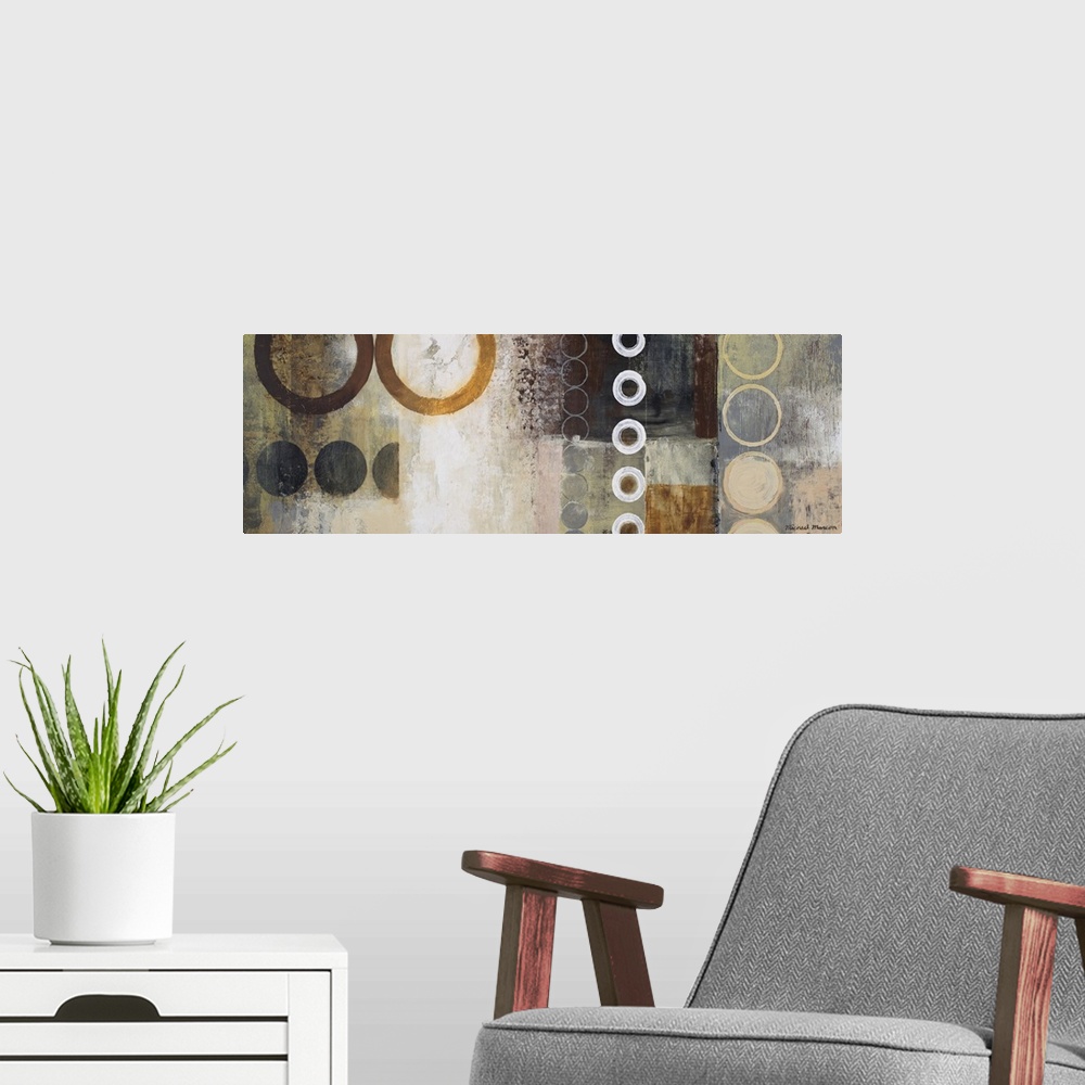 A modern room featuring Panoramic abstract painting of different sized circles over top of a grungy background.