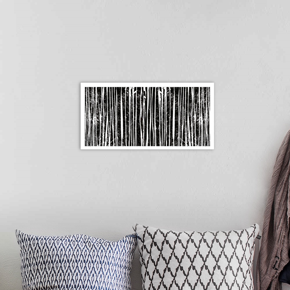 A bohemian room featuring Abstract artwork of several vertical black and white lines.