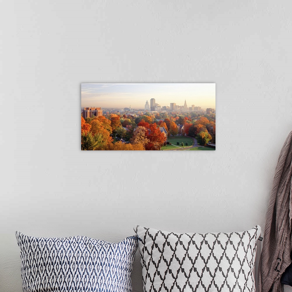 A bohemian room featuring Fall foliage in bright colors with views of the city of Hartford, CT in the background.