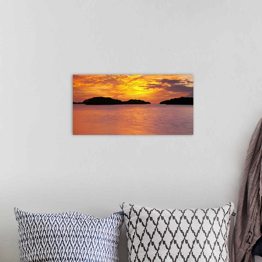 A bohemian room featuring Large canvas photo of a vibrant sunset reflected in calm waters.