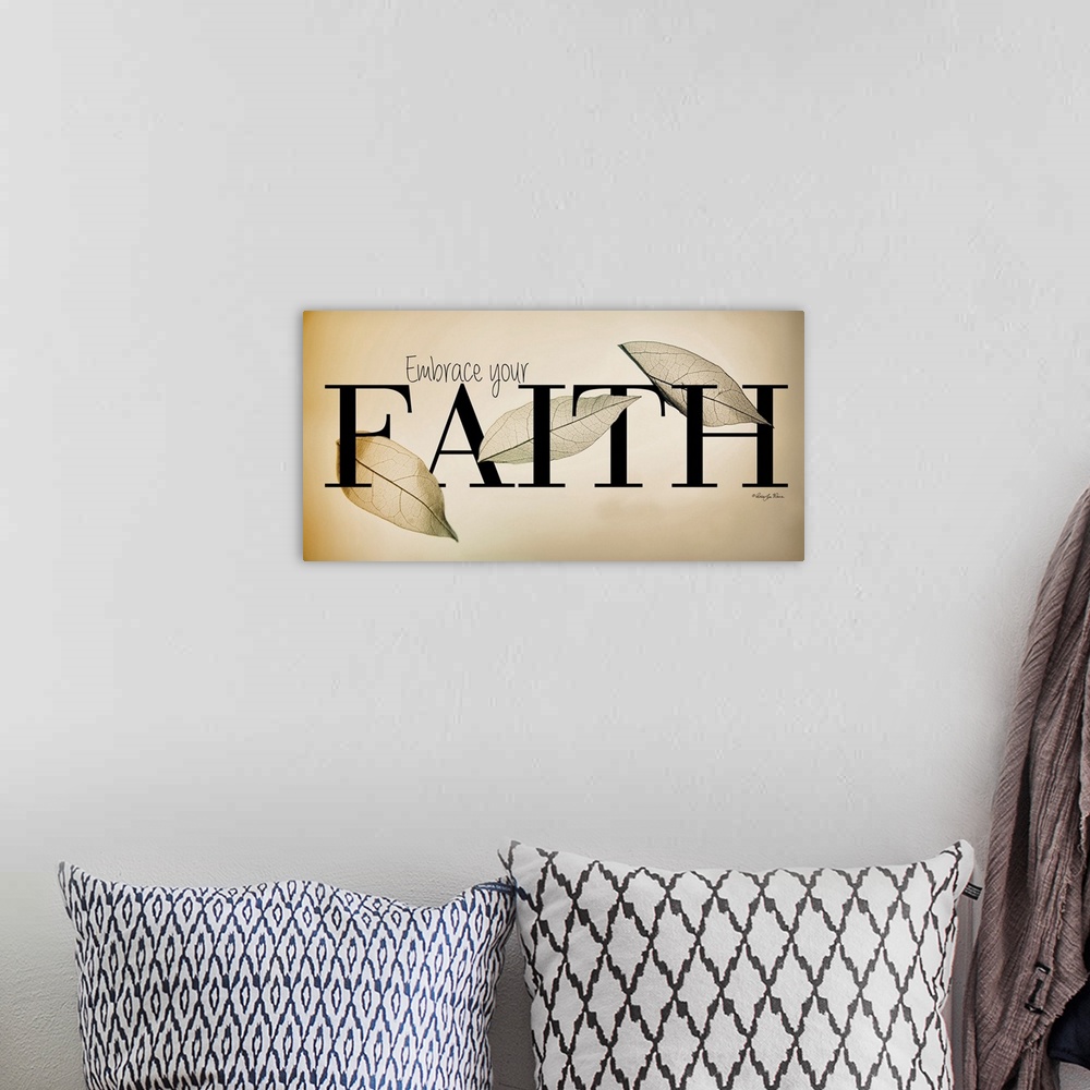 A bohemian room featuring Religious typography art with a leaf design on neutral colors.