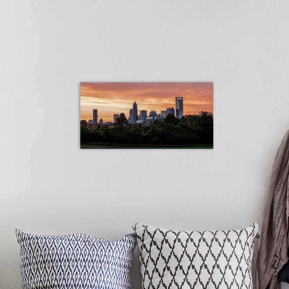 A bohemian room featuring The sun setting on the largest city in North Carolina.