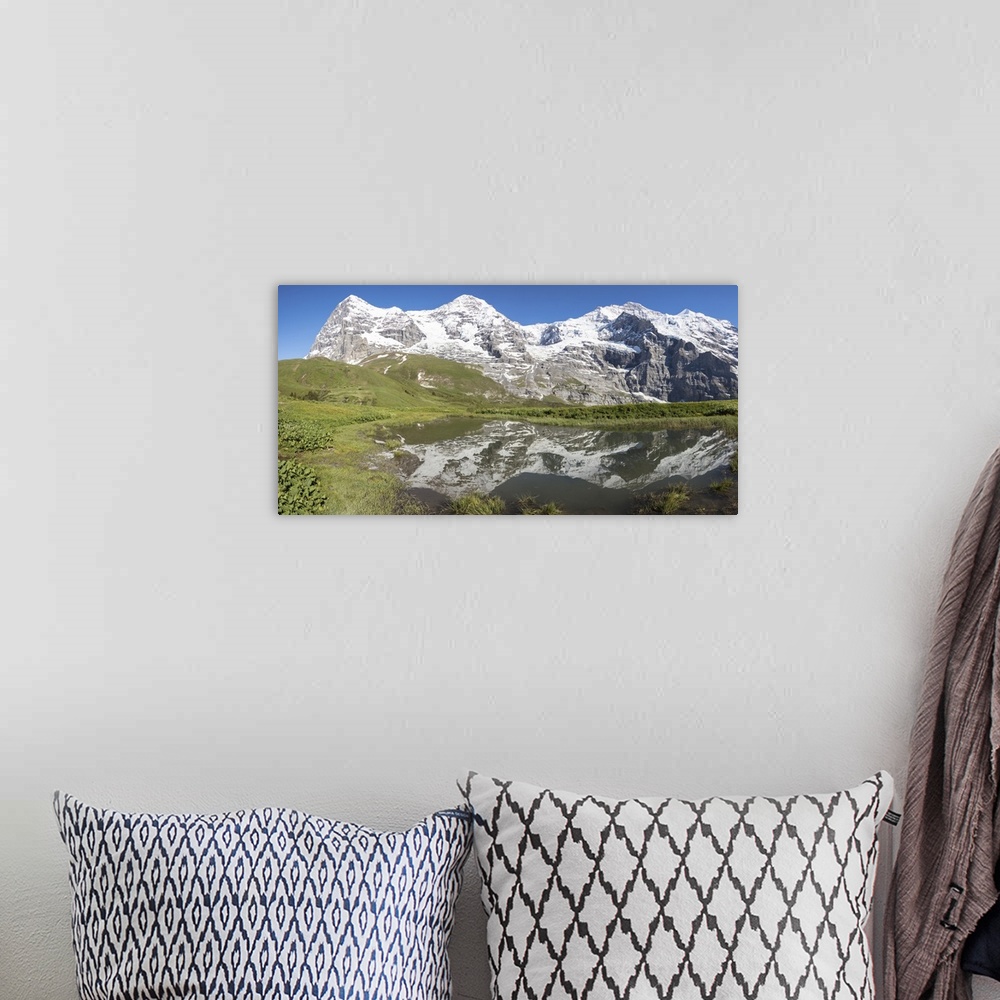 A bohemian room featuring Panorama of snowy peaks reflected in the alpine lake, Wengernalp, Wengen, Bernese Oberland, Canto...