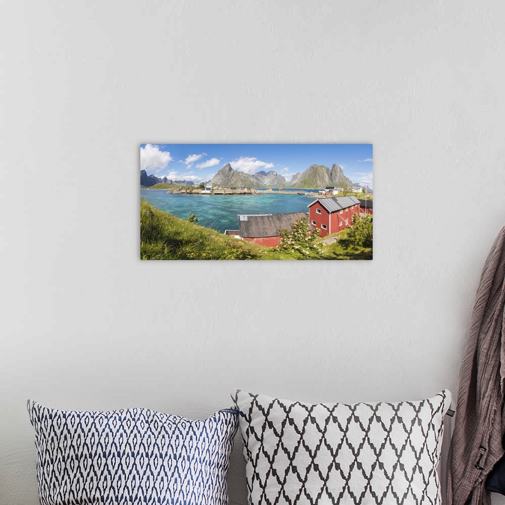 A bohemian room featuring Panorama of turquoise sea and typical fishing village surrounded by rocky peaks, Sakrisoy, Reine,...