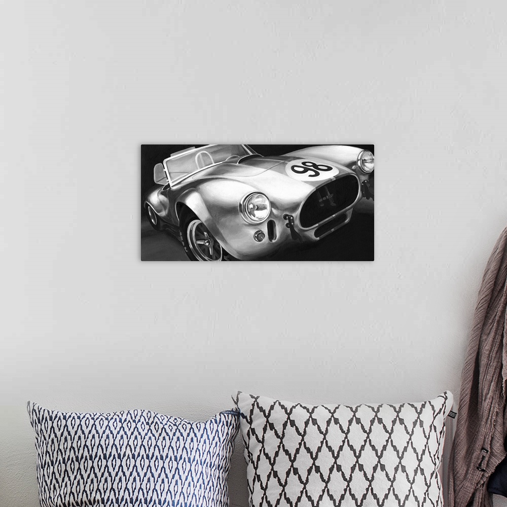 A bohemian room featuring Photograph of classic muscle car with a convertible top and a 98 emblem circle on the hood.