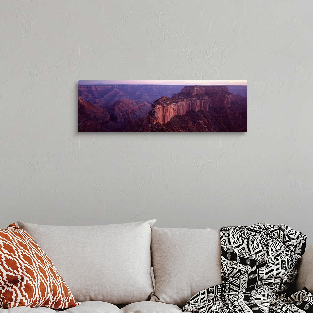 A bohemian room featuring This aerial wide angle shot is taken of the vast Grand Canyon during dusk and only a sliver of th...