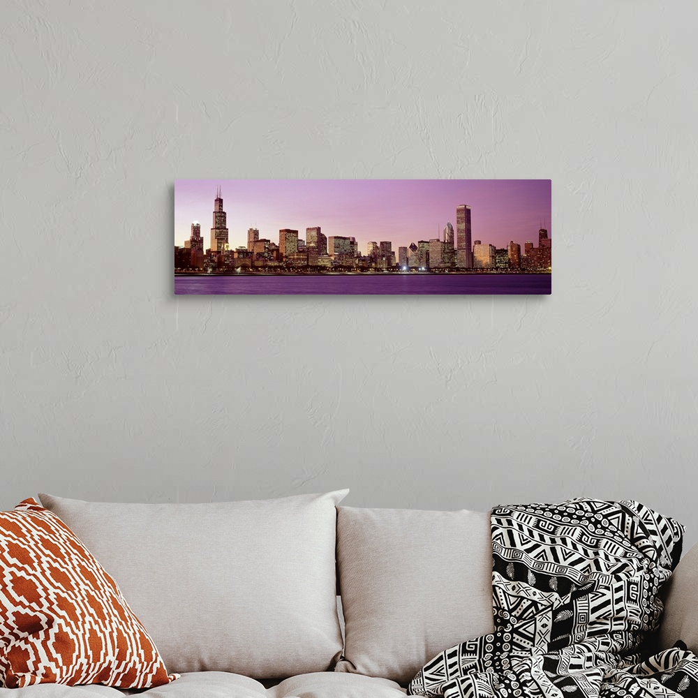 A bohemian room featuring The Chicago skyline lit up at night from across the water in Illinois.