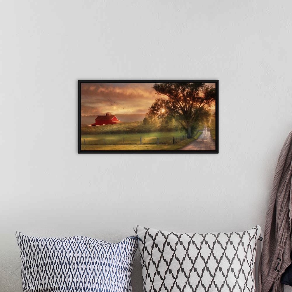 A bohemian room featuring A dirt road in the countryside with a red barn in the distance at sunset.