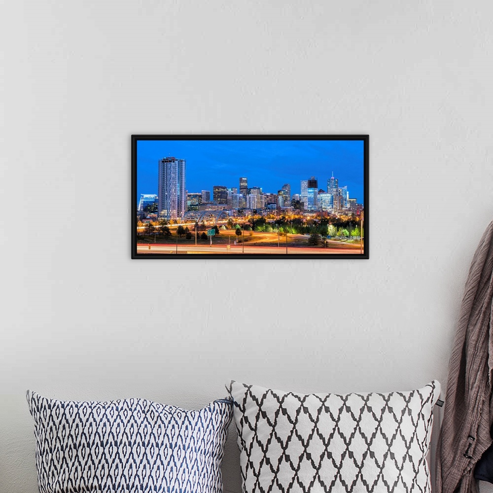 A bohemian room featuring Photograph of the Denver, CO skyline at dusk with warm light trails on the highway from passing c...