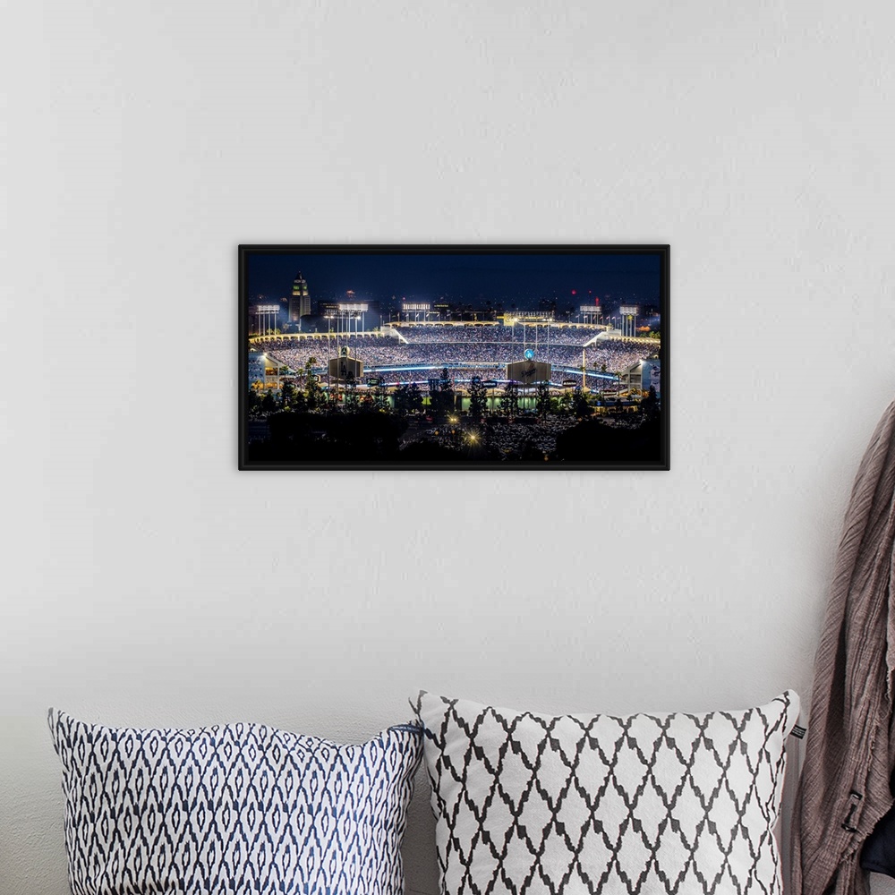 A bohemian room featuring Panoramic photograph of Dodger Stadium lit up on a game night.