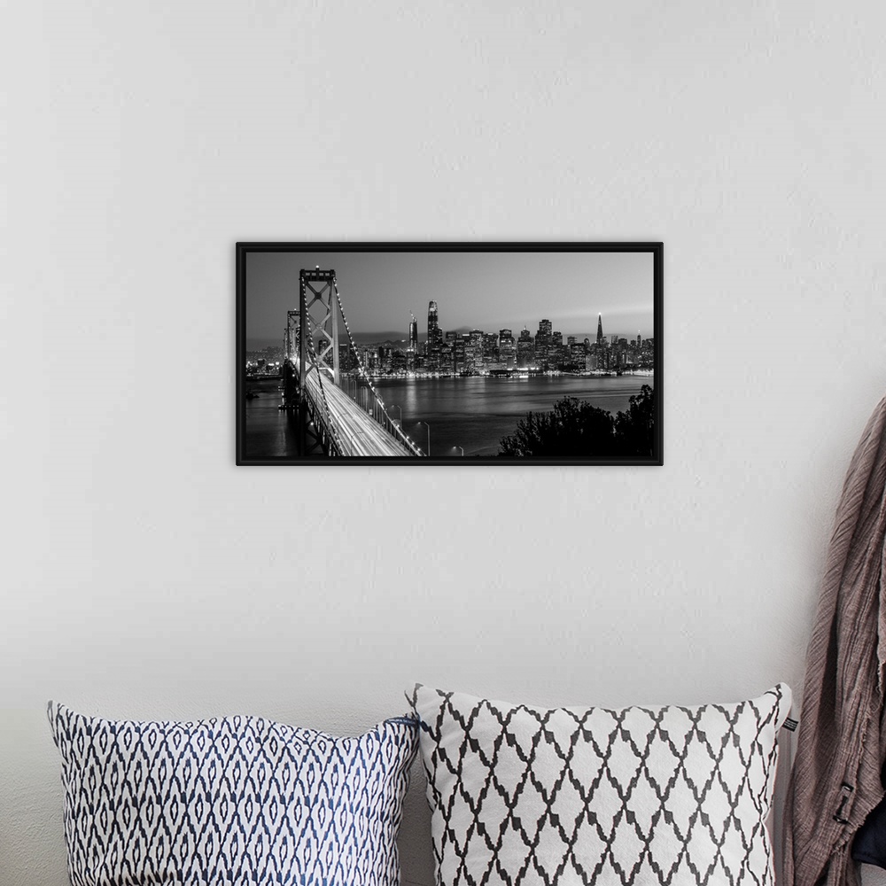 A bohemian room featuring Photograph of the Bay Bridge with a sunset and the San Francisco skyline lit up in the background.