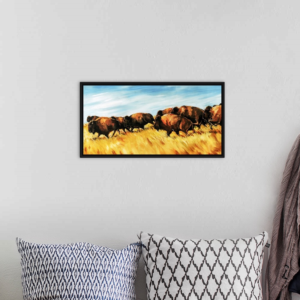 A bohemian room featuring Painting of a herd of buffalo running wild on a grassy plain.