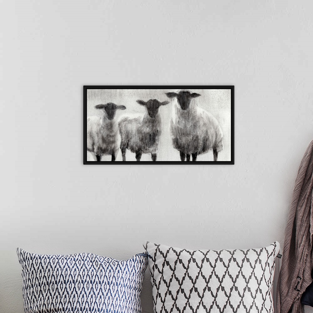 A bohemian room featuring Monochrome painting of three woolly sheep in a field.