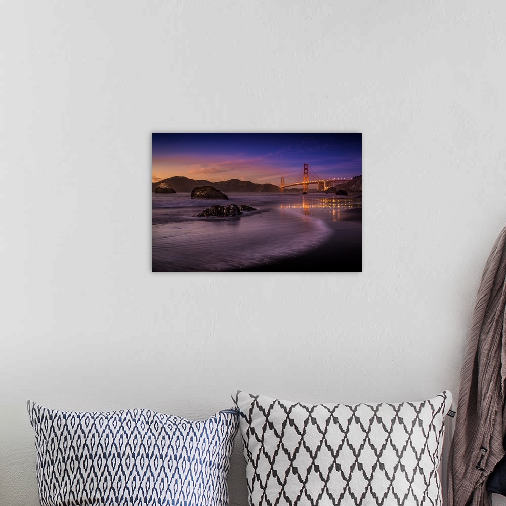 A bohemian room featuring Lights on the Golden Gate Bridge in San Francisco seen from the beach at twilight.